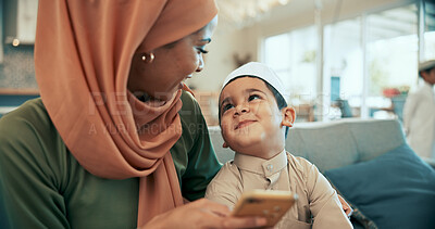 Buy stock photo Muslim, mother and son on sofa in home, smartphone and love or bonding with islamic family together in living room. Smile, adoration and child development with woman, happy kid and Malaysian people