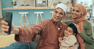 Buy stock photo Muslim family, happy and portrait selfie on sofa, together and bonding with boy. Hijab mother, father and child in picture for islamic new year memory, celebration capture and Muharram mubarak
