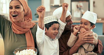 Buy stock photo Muslim family, home and celebration for television in living room, children and Islamic parents with boys together. Popcorn, movie and entertainment with Malaysian people, happy and streaming sports