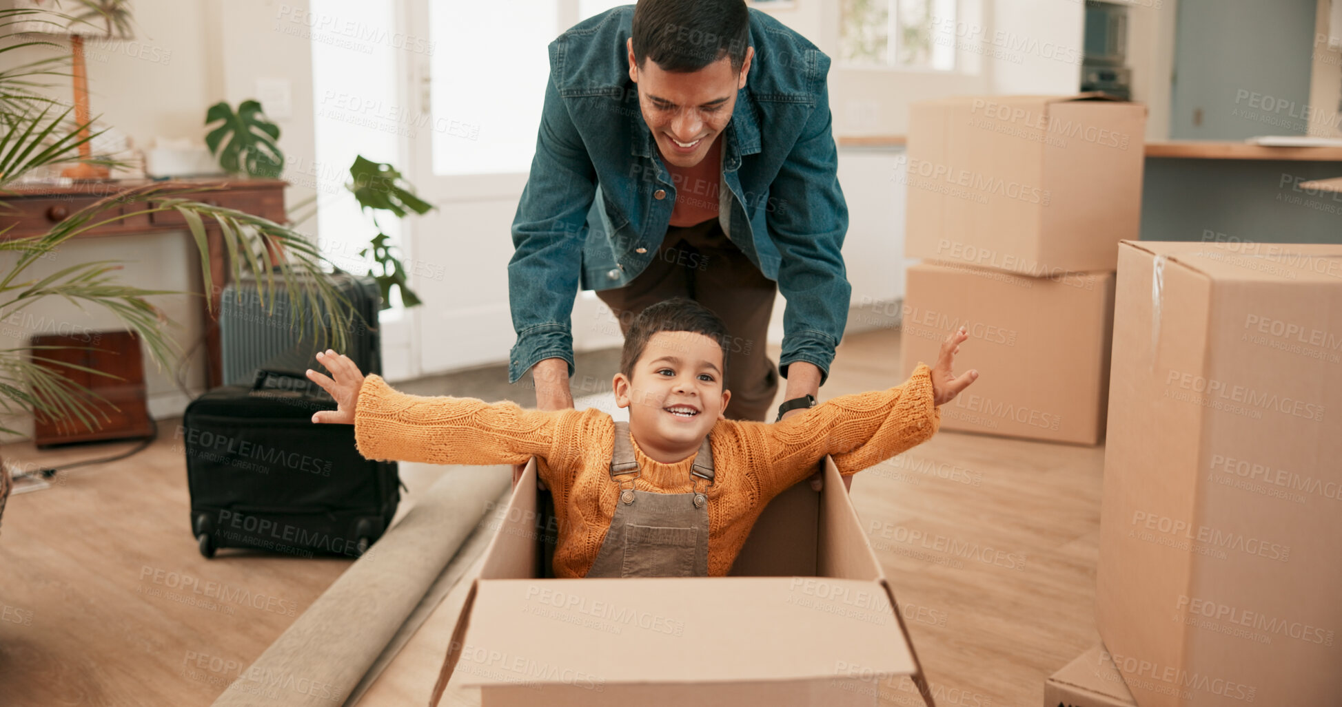 Buy stock photo Father, boy and push box in new home with smile for plane, spaceship or speed with celebration at property. Excited child, man and happy with cardboard container, games and moving to family house