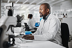 Science, lab and research with black man and computer for microscope data analysis and report. Working, scientist and medical journal study with technology and professional with healthcare article