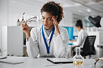 Stress, woman and scientist with glasses in laboratory with chemical liquid and tablet for research. Exhausted, headache and female chemist with digital technology for medical discovery or experiment