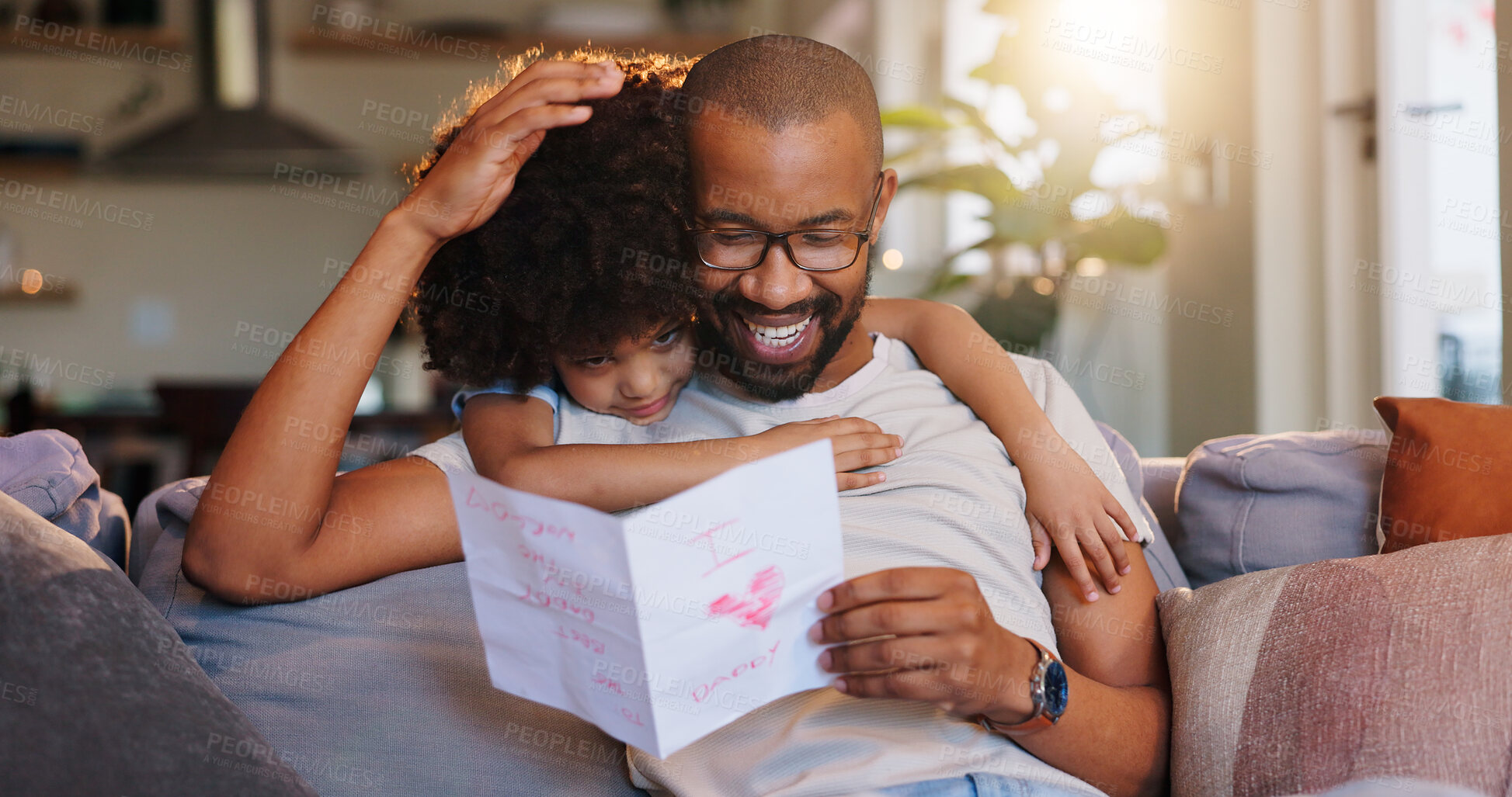 Buy stock photo Card, hug and dad with child in home for fathers day celebration with bonding together. Happy, love and black man embracing boy kid with care for drawing gift on sofa in living room at family house.