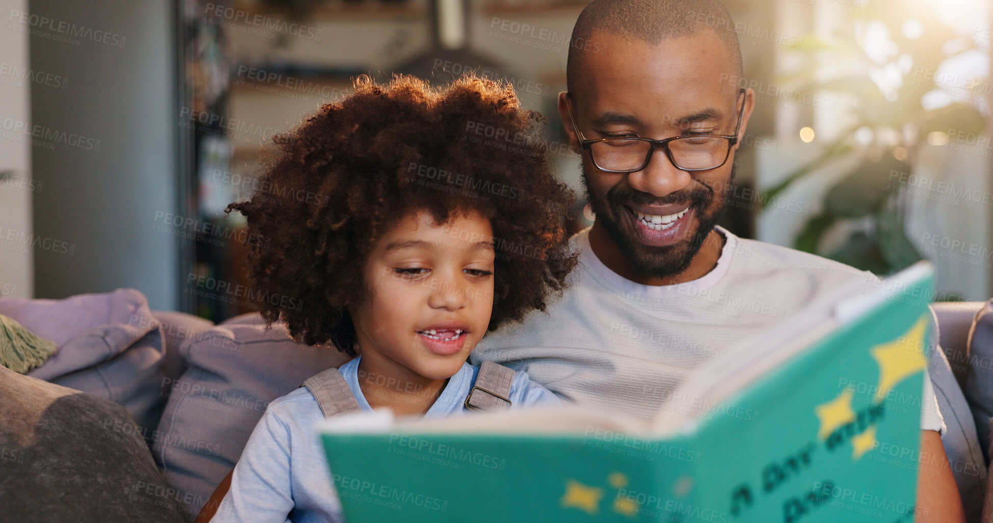 Buy stock photo African father, boy and reading with story on sofa, listening and bonding in morning at family house. Man, son and together with book, happy and relax with love, literature and learning in apartment