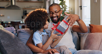 Buy stock photo Happy father, son and gift with box for birthday surprise, childhood or bonding on sofa at home. Dad giving child, kid or little boy present, parcel or package with ribbon for appreciation at house