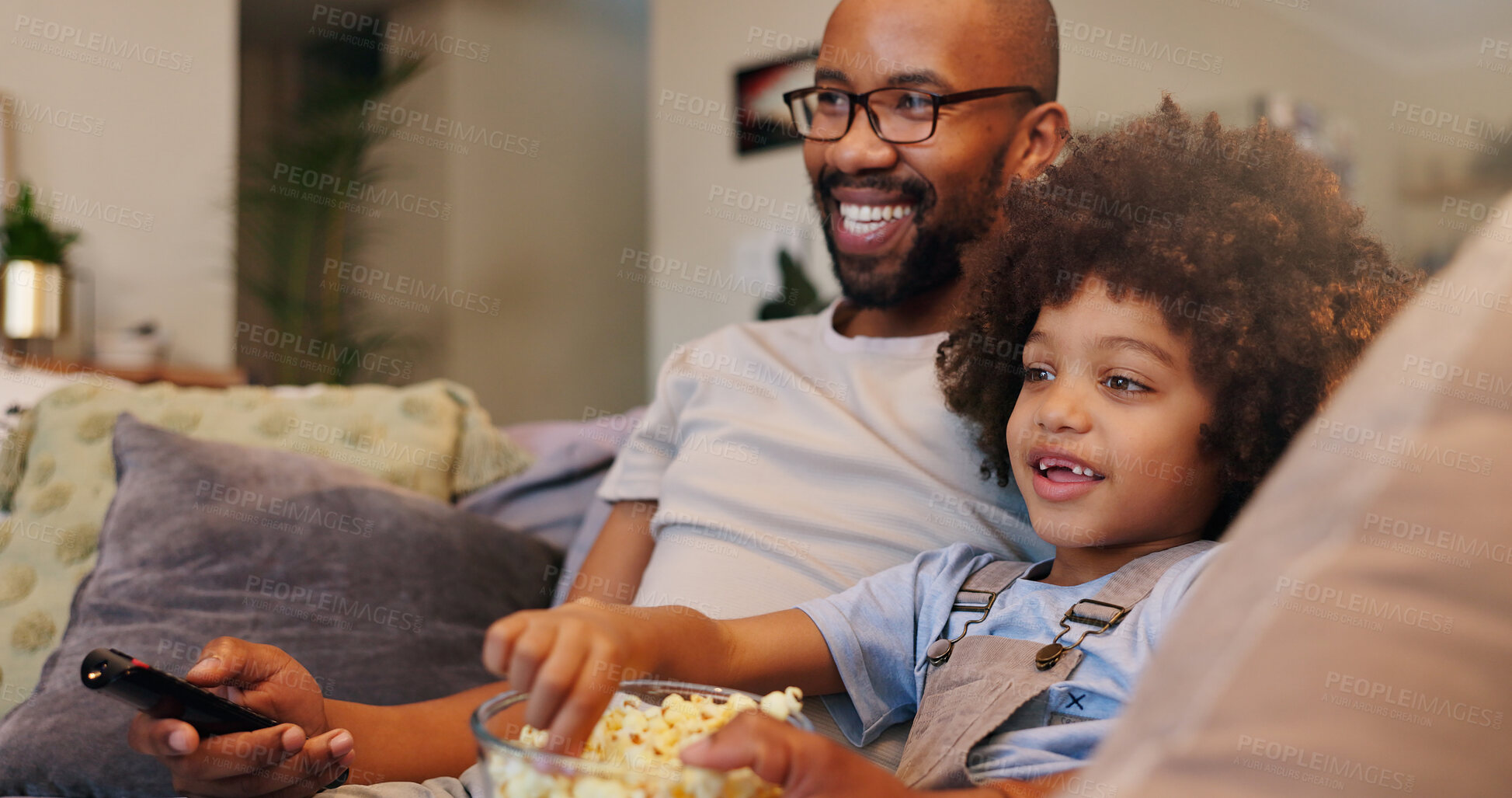 Buy stock photo Father, boy and happy with television or popcorn on sofa in living room for movies, cartoon and entertainment. People, parent and smile with kid at home for streaming platform with child development