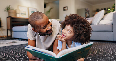 Buy stock photo Reading, father and child with book on floor for education, learning or language development in living room. Love, African man and boy lying on rug for literacy, storytelling or knowledge in home