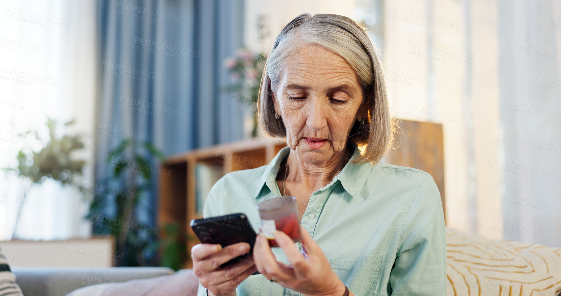 Buy stock photo Home, pills and elderly woman with phone for healthcare information, advice and research on medicine. Retirement, telehealth and senior person with container for reading label, dosage or side effects