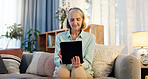 Senior woman, tablet and typing on sofa for web surfing with retirement, chess game and connection in home. Elderly lady, tech and relax with reading ebook, online puzzle and internet scroll on couch