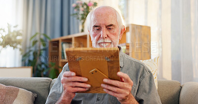 Buy stock photo Retirement, senior man and frame with nostalgia, memories and reflection of past with picture on sofa. Home, old person and remember with wooden album, photo or cognitive trigger with journey of life