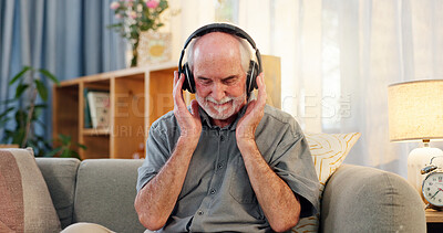 Buy stock photo Home, senior man and happy with headphones for music, playlist and online radio. Sofa, living room and smile with earphones to relax as pensioner for fun, entertainment and audio for relaxation.