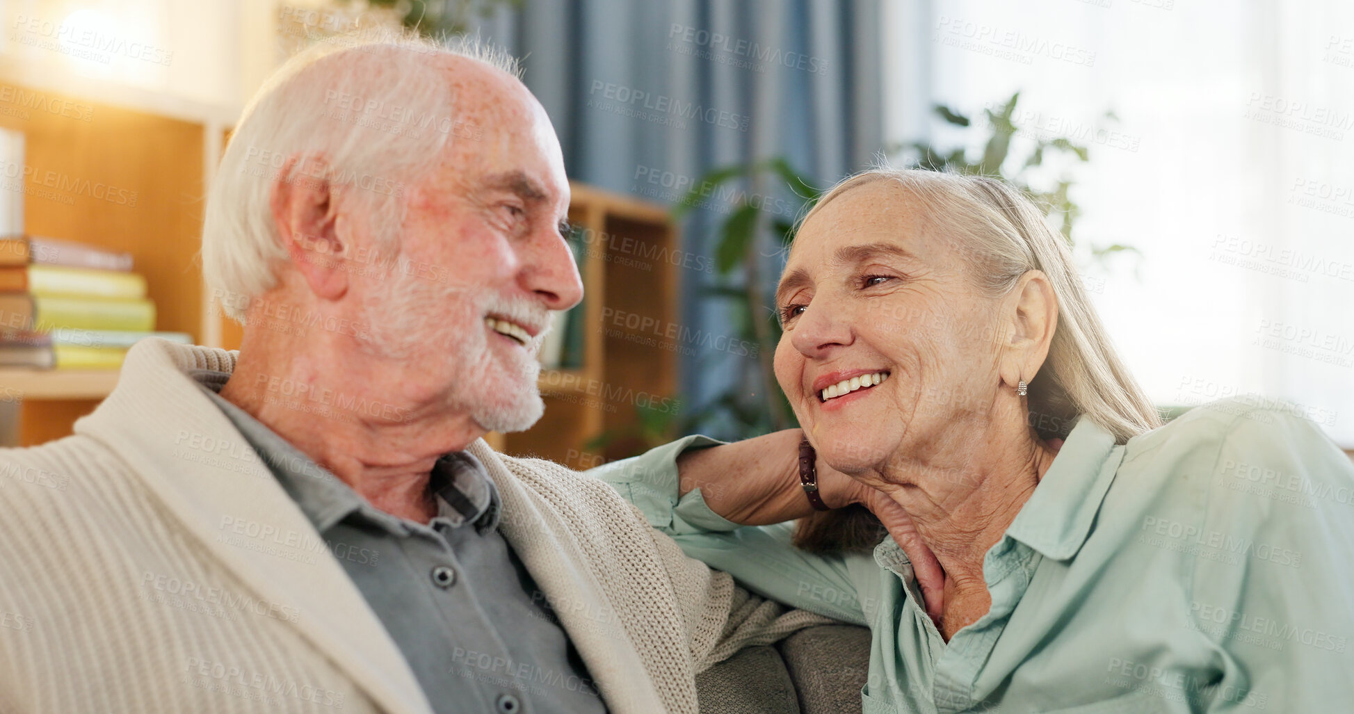 Buy stock photo Senior couple, happy and smile in home together, caring and bonding in retirement break or living room in apartment. Comfortable, love and respect for marriage relationship, trust and commitment