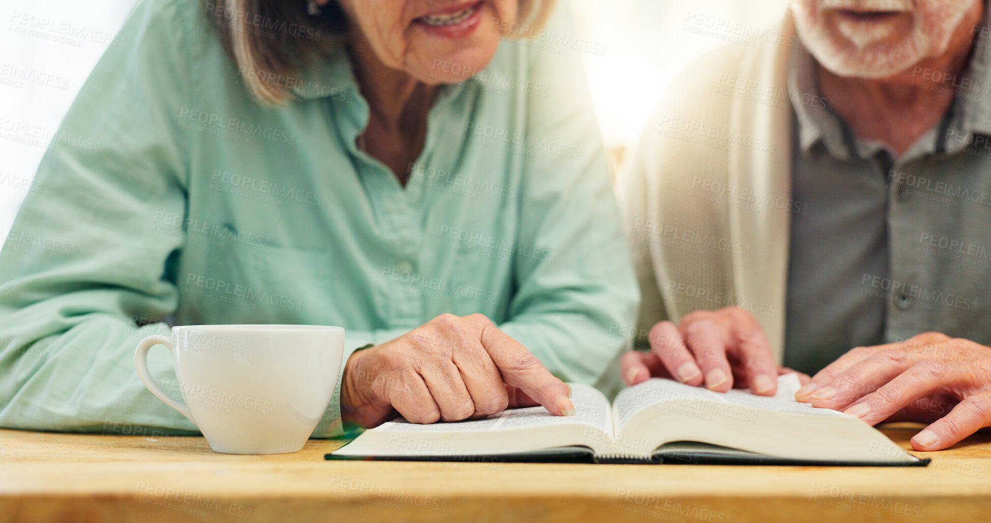 Buy stock photo Bible, hands and reading with senior couple drinking tea at table in apartment together for belief or faith. Book, Jesus or God with man and woman in retirement home for Christian religion or study