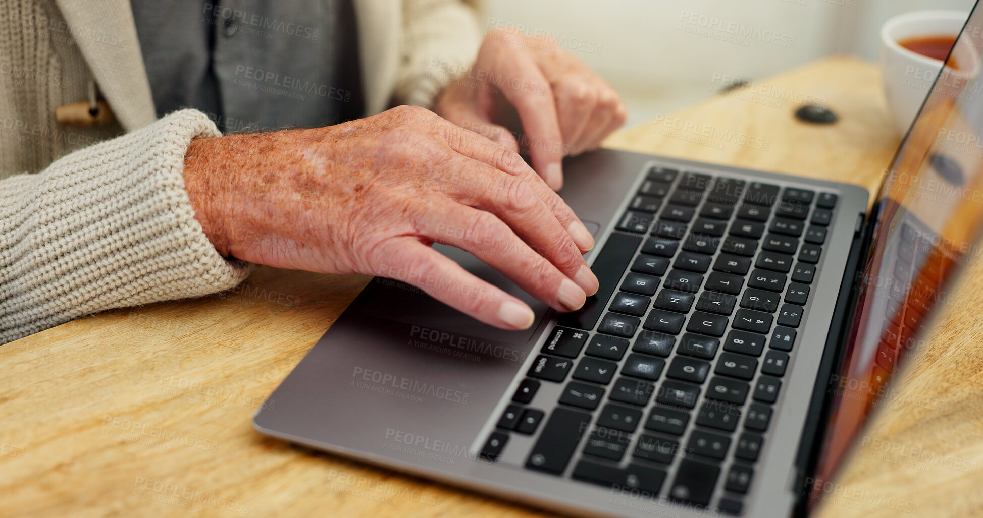 Buy stock photo Laptop, typing or hands of senior man for telehealth, communication or online consultation at home. Elderly male person, technology or reading at table for healthcare, research or medical information