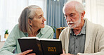 Senior couple, home and reading bible for religion or spiritual practice, knowledge and study. People, relationship and couch with scripture for healing, hope and faith with support as Christians