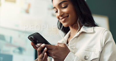 Buy stock photo Texting, online and Indian woman with smile, office and streaming of music in app and communication. Employee, typing and resignation letter in email for business, happy and listening to podcast