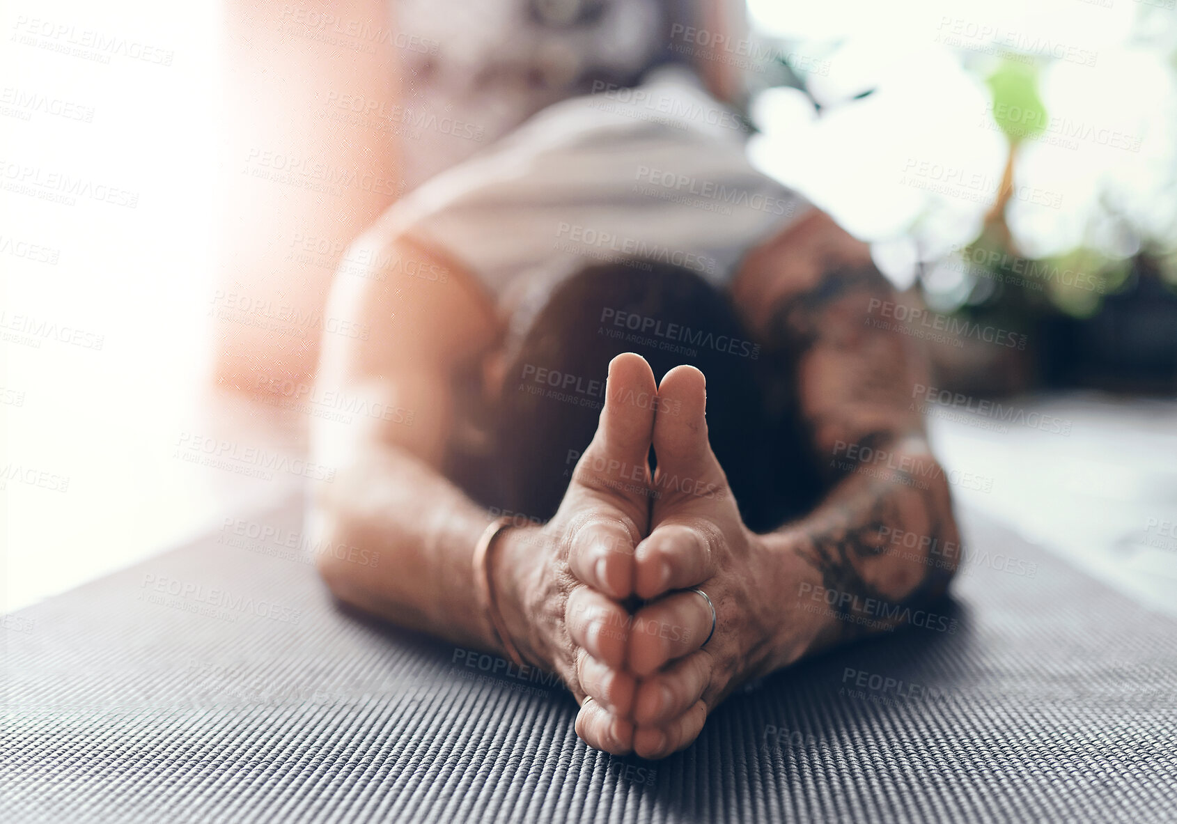 Buy stock photo Shot of a young man going through a yoga routine at home