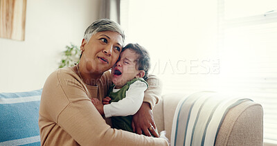 Buy stock photo Home, granny and hug for crying baby, sad and comfort in living room, embrace and love. Apartment, grandmother and senior woman with infant, boy and tears with care, autism and kindness in lounge