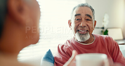 Buy stock photo Senior couple, smile and talking in home for bonding, love and healthy relationship. Retirement, happy man and woman in living room for conversation, support and drinking coffee to relax in house