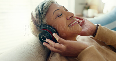 Buy stock photo Retirement, mature woman and sofa with headphones, relax and calm in living room, streaming music and audio. Rest, happy and senior lady with headset for podcast, radio and carefree on couch