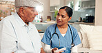 Senior care, doctor or retired man on sofa for discussion, information for pills or help in living room. Female carer, elderly patient or scheduled meds on couch for healthcare, wellbeing or medicare