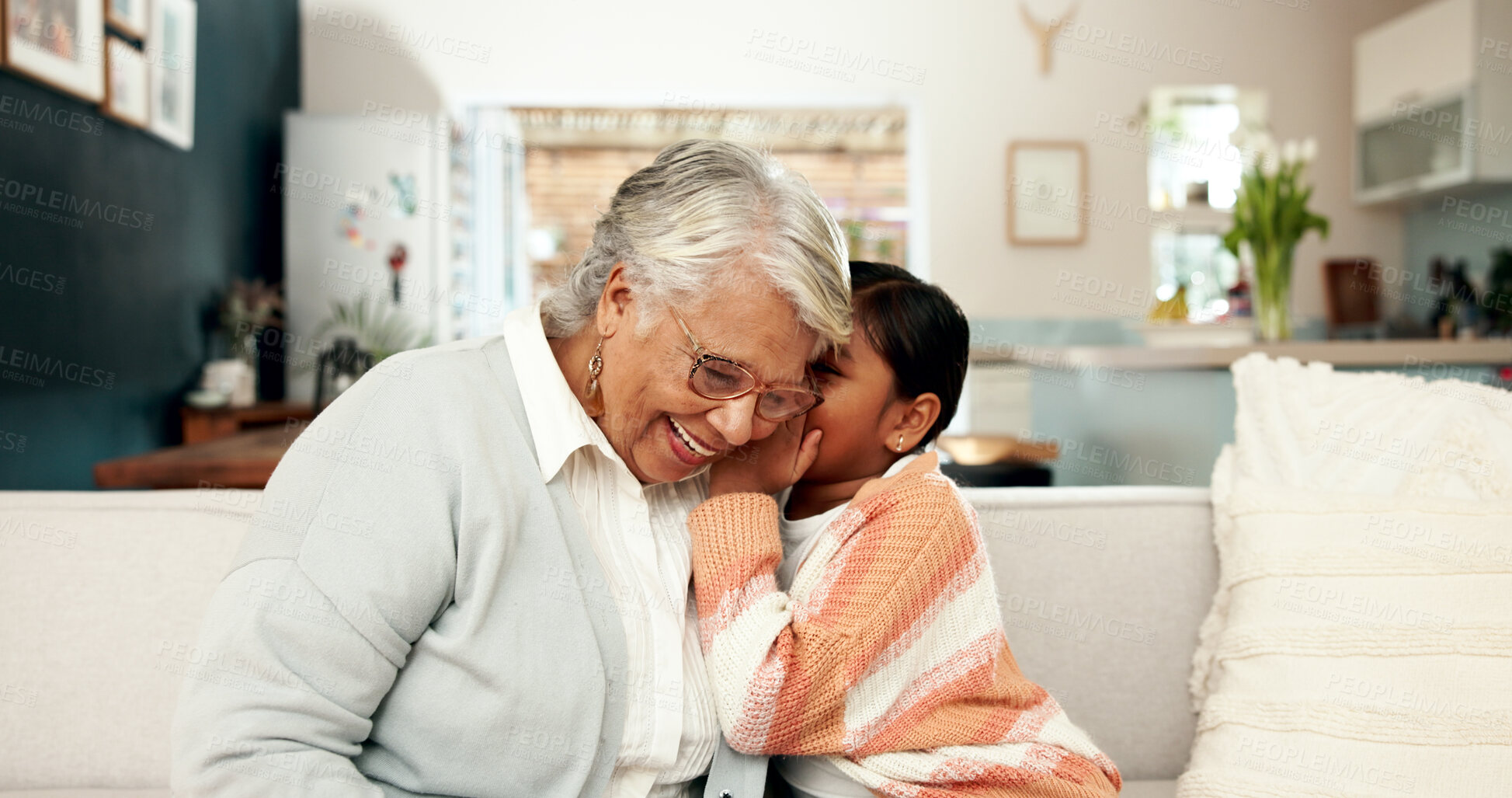 Buy stock photo Secret, child and grandmother in living room, home and whisper for funny joke in ear. Bonding, sofa and lounge of family house with girl and female person, confidential and private conversation