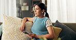 Woman, home and thinking on sofa with smartphone for online news, blog and social media. Female person, couch and living room with though on website on application for study or educational loan