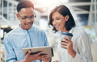 Buy stock photo Shot of a young businessman and businesswoman using a digital tablet in a modern office