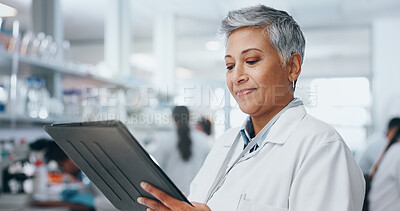 Buy stock photo Mature woman, science and tablet in laboratory for discovery, innovation or pharmaceutical research. Breakthrough, investigation and medicine with happy scientist reading medical info for development