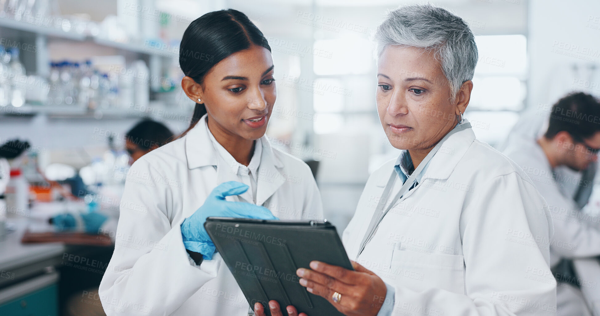 Buy stock photo Tablet, women and scientists in laboratory with research for pharmaceutical innovation experiment. Internship, discussion and mentor with medical science student on digital technology for feedback.