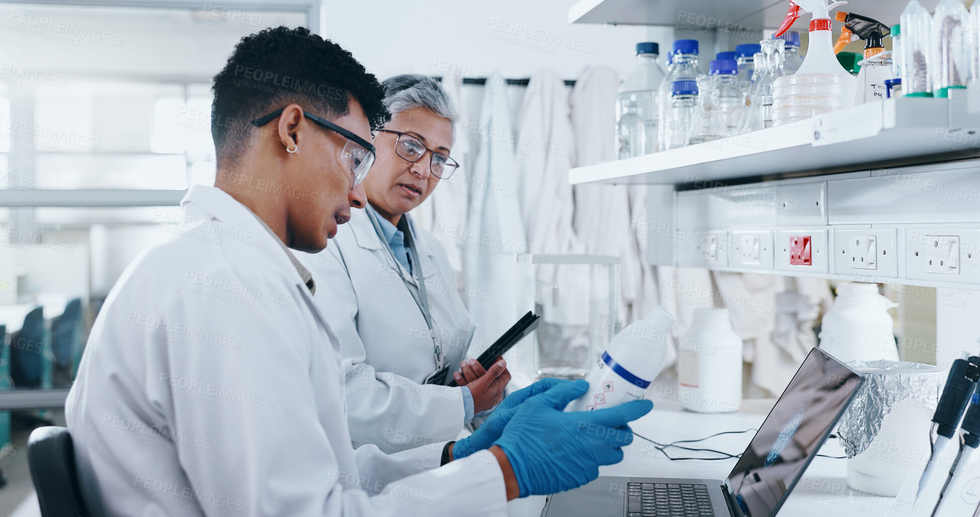 Buy stock photo Science, people and lab discussion for research, mature woman and mentor with tablet for experiment compliance report. Man, chemical bottle and catalyst with laptop, advice and talking together