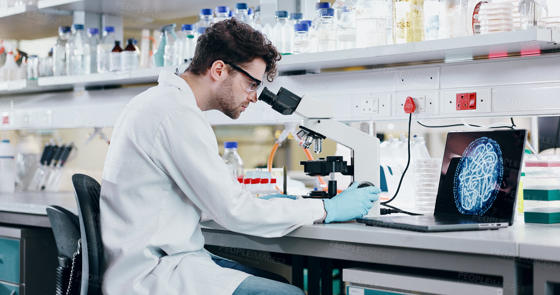 Buy stock photo Medical, research and man with microscope, science and check experiment for cancer treatment. Person, scientist and employee with lab equipment, laptop and cure development with particles and biotech