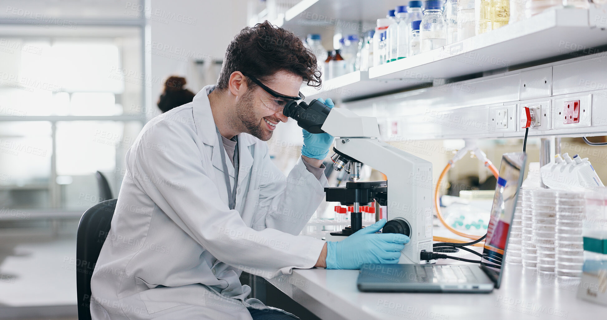 Buy stock photo Biotech, research and man with microscope, science and check experiment for cancer treatment. Person, scientist and employee with lab equipment, vaccine or sample for monkeypox and studying particles