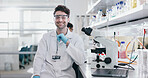 Portrait, science and smile of man on microscope in lab to research chemistry, test or innovation. Laptop, scientist and face of medical doctor in goggles for microbiology, healthcare or pharma study