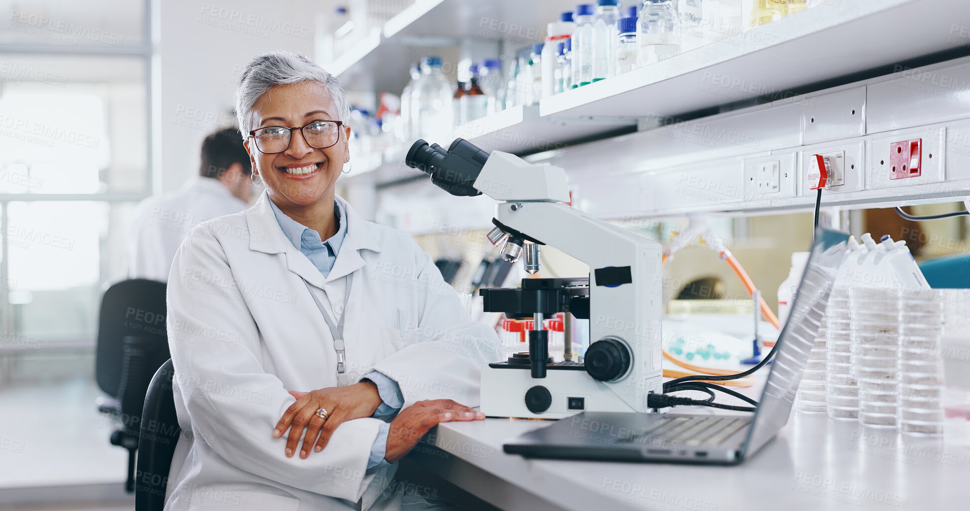 Buy stock photo Portrait, scientist and mature woman on laptop in lab to research chemistry, test or innovation. Microscope, science and happy medical doctor in glasses for microbiology, healthcare and pharma study