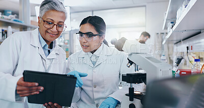 Buy stock photo Science, team and tablet in lab for research, vaccine development or online feedback. Women, technology or discussion at microscope for test results, medical report or virus study for pharmaceuticals