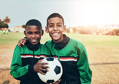 Buy stock photo Portrait of two young boys playing soccer on a sports field