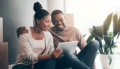 Buy stock photo African couple, real estate and tablet for new house interior shopping, property or relax on floor with boxes. Realtor, happy online communication and homeowners moving or packing apartment together