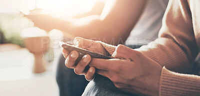 Buy stock photo Closeup shot of an unrecognisable couple using their digital devices at home