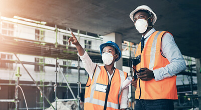 Buy stock photo Shot of a young man and woman having a discussion while working at a construction site