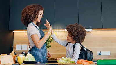 Buy stock photo Mom, child and happy high five in kitchen for development, learning recipe and cooking success in home. Mama, young boy and celebrate with palm connection, support and motivation for food preparation