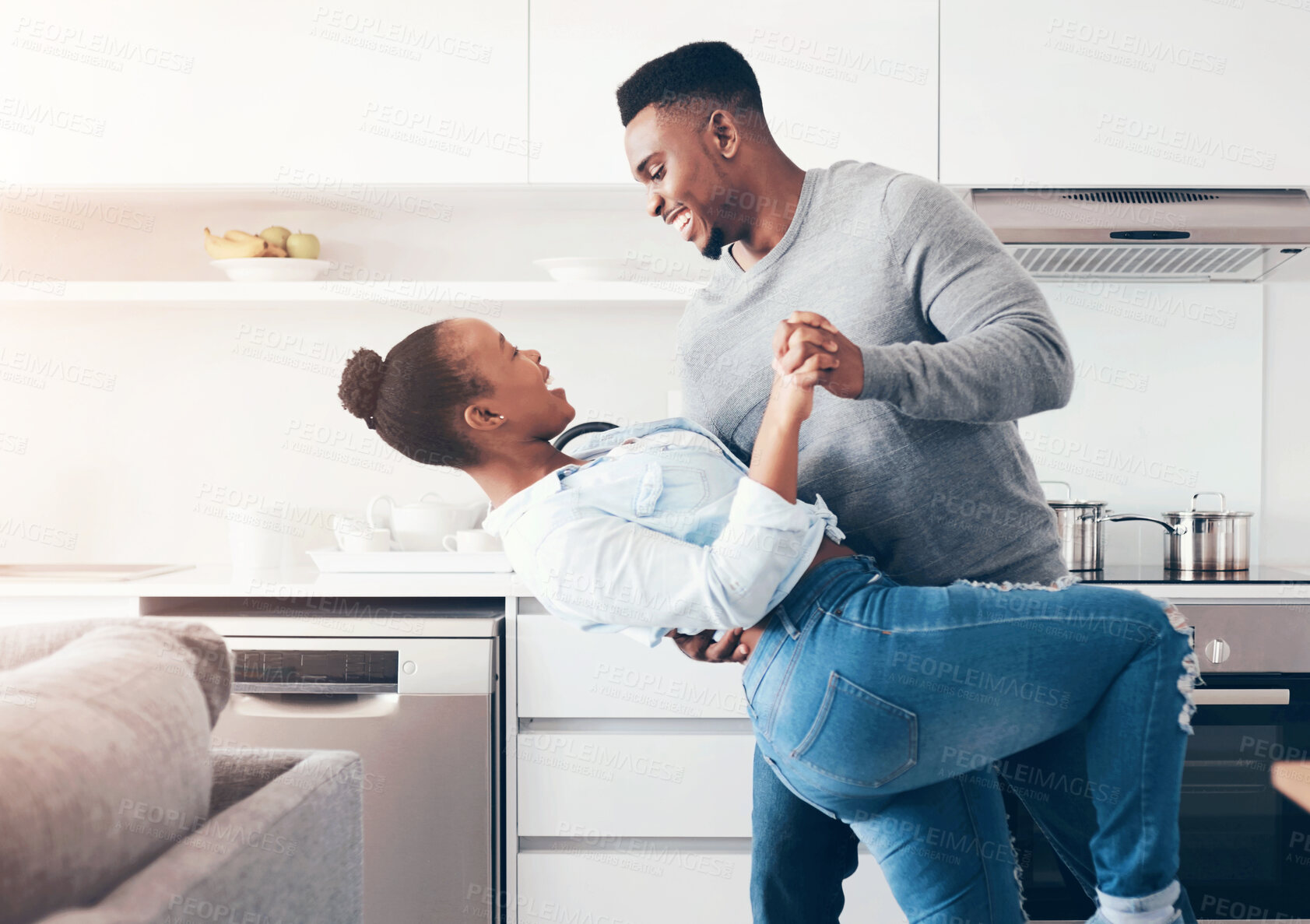 Buy stock photo Black couple, dancing and home for love, support and music for weekend rhythm in kitchen. Happy people, profile and romance in partnership or relationship, connection and dip for playful bonding