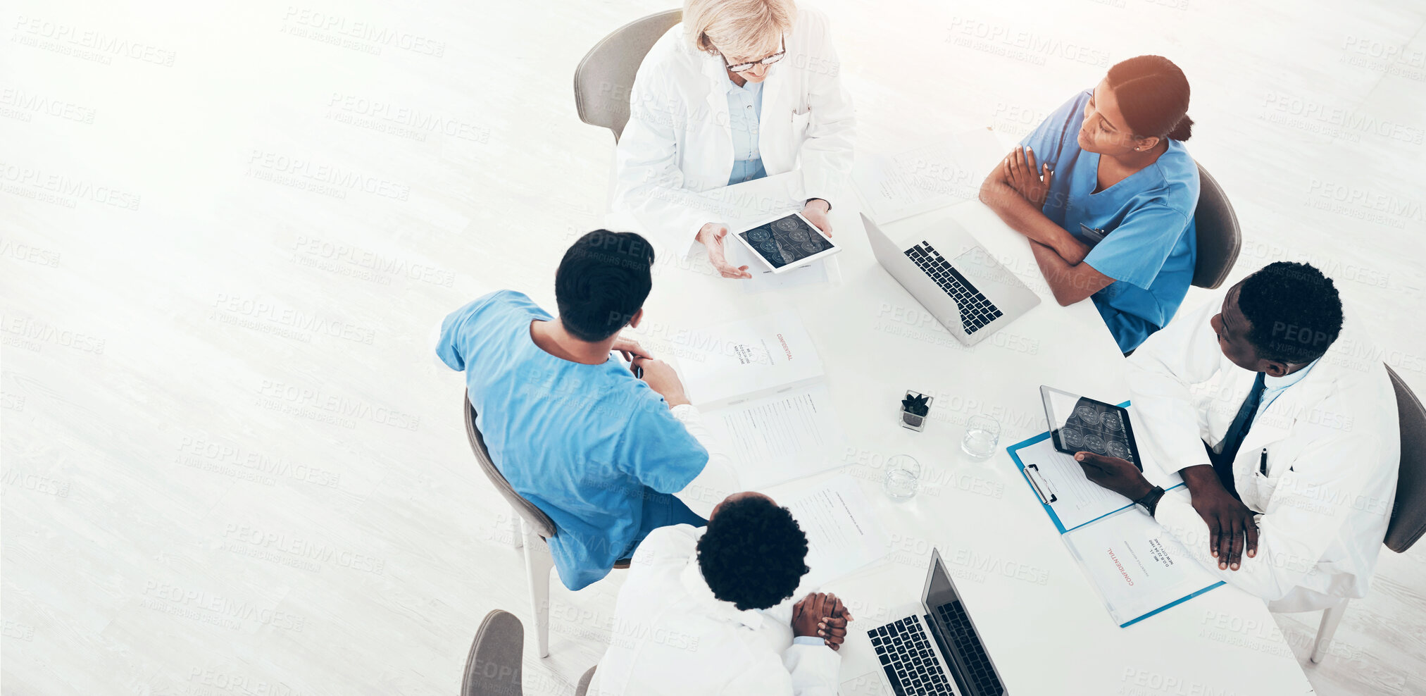 Buy stock photo High angle shot of a group of medical practitioners having a meeting in a hospital boardroom