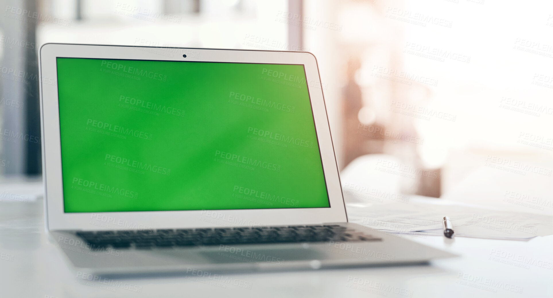 Buy stock photo Shot of a laptop with a green screen on a desk in a modern office