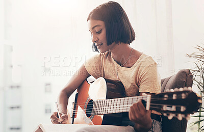 Buy stock photo Girl, guitar and writing music in home for audio production, song composition and practice for performance. Musician, artist and planning notes for track recording, creative lyrics or record producer