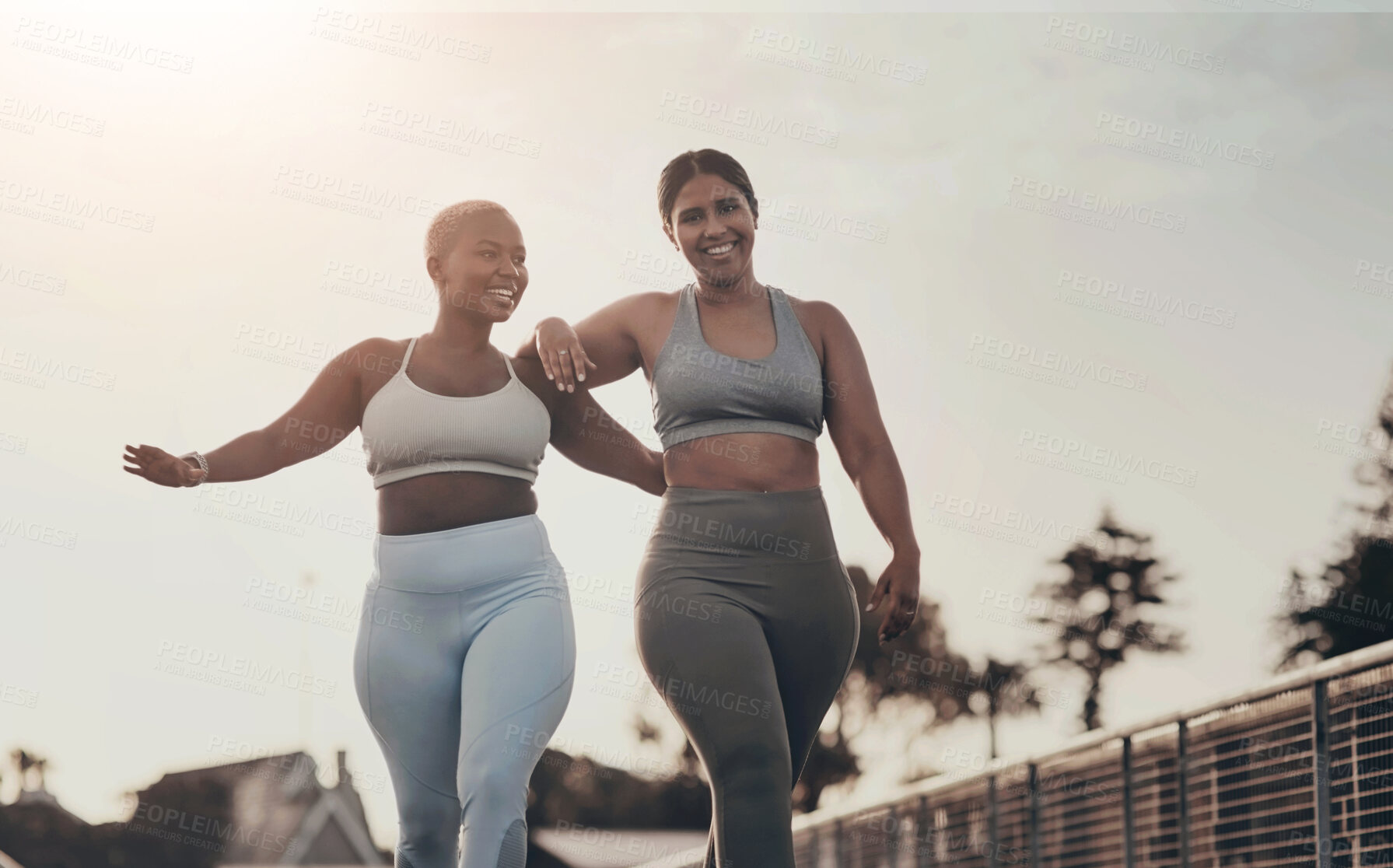 Buy stock photo Shot of two young women out for a run together