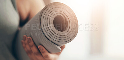 Buy stock photo Closeup shot of an unrecognisable woman carrying an exercise mat