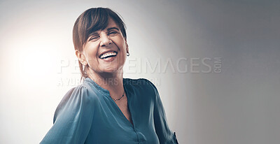 Buy stock photo Studio portrait of a senior woman standing with her hands on her hips against a grey background