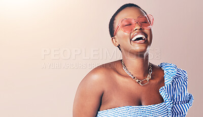 Buy stock photo Happy, black woman and laughing with sunglasses for fashion, style or beauty on a studio background. Young African, female person or model smile with stylish outfit for summer season on mockup space