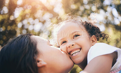 Buy stock photo Mother, child and kiss in nature, smile or bonding on  summer holiday vacation. Mom, kissing cheek and happy girl, love and affection, care and enjoying quality family time together outdoor in park.